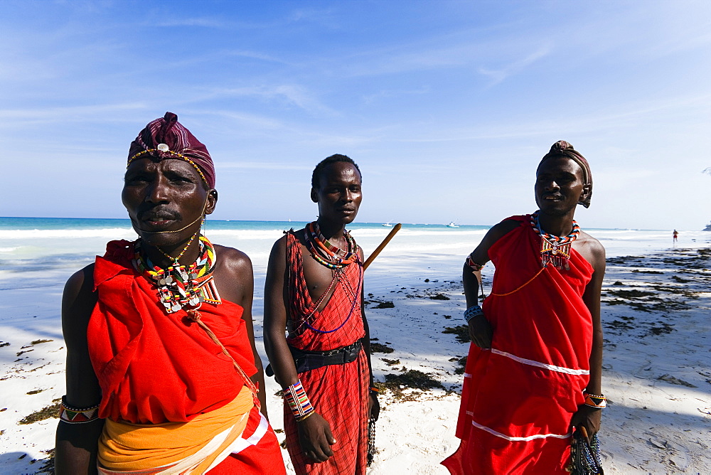 Three plastic Massai wearing traditional clothing at Diani Beach, Coast, Kenya