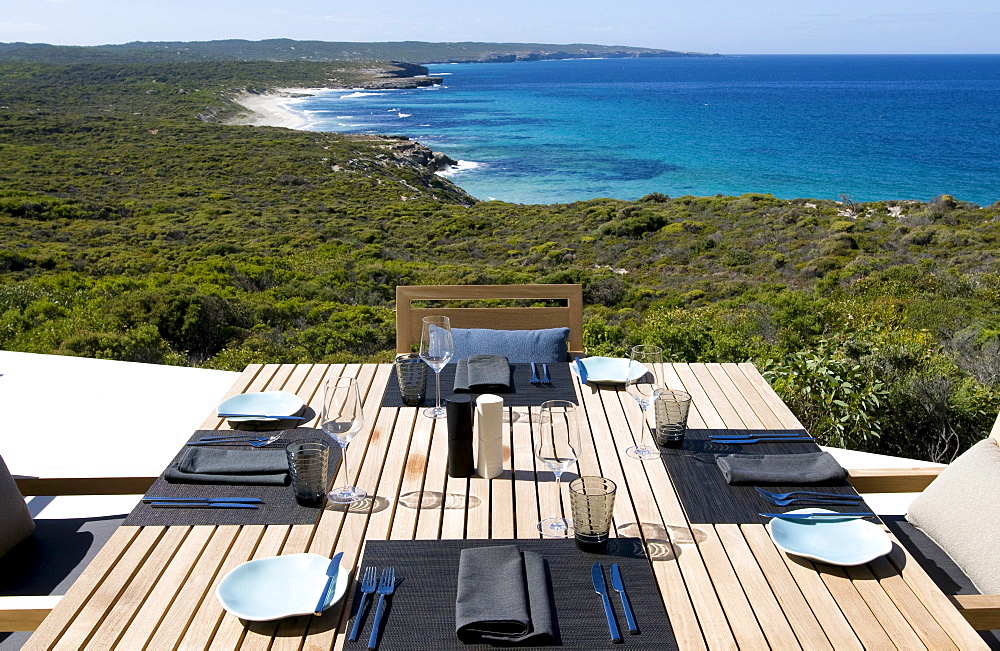 A table is laid on the terrace of the Southern Ocean Lodge with view at Hanson Bay, Kangaroo Island, South Australia, Australia