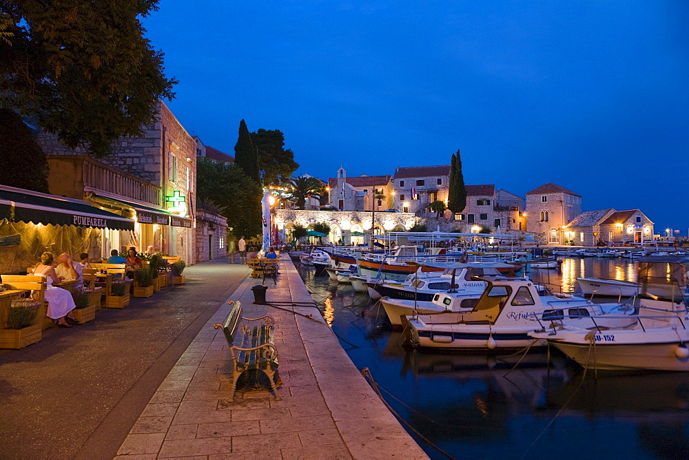 People sitting in front of a tavern at Bol harbour in the evening, Brac Island, Dalmatia, Croatia, Europe