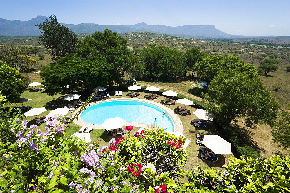 View over swimming pool of Taita Hills Lodge, Taita hills in background, Coast, Kenya