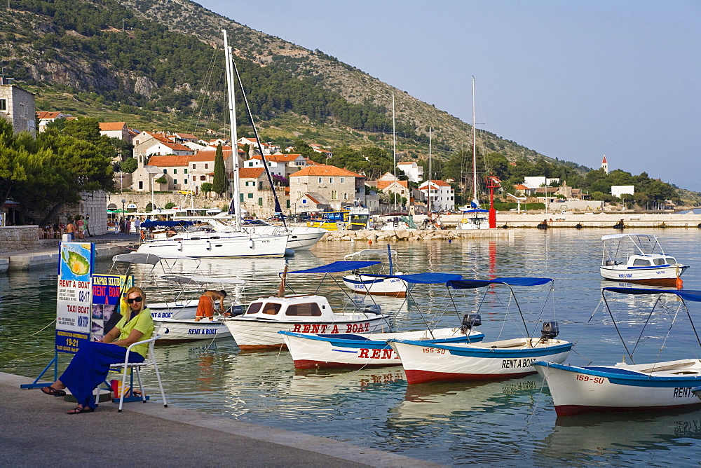 Boats are moored at Bol harbour in the sunlight, Brac Island, Dalmatia, Croatia, Europe