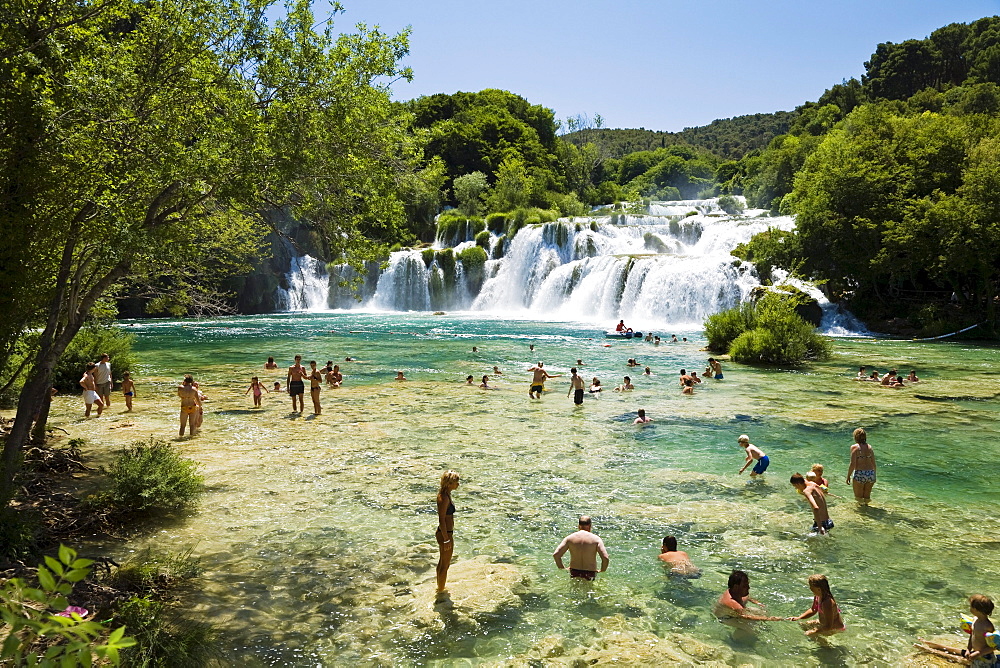 People bathing in the river at Krka waterfalls, Krka National Park, Dalmatia, Croatia, Europe