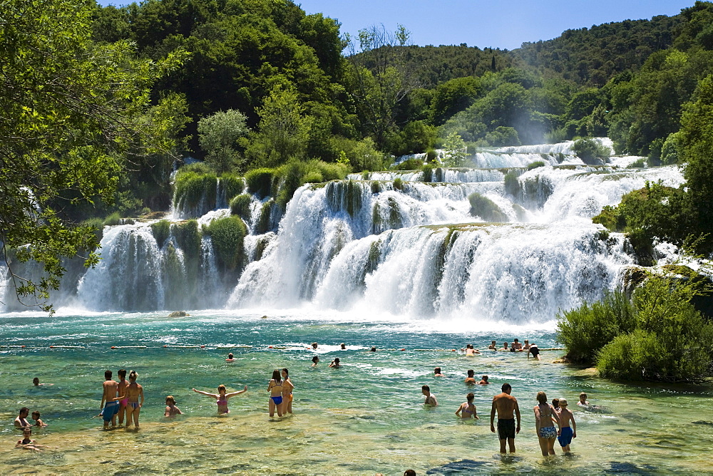 People bathing in the river at Krka waterfalls, Krka National Park, Dalmatia, Croatia, Europe