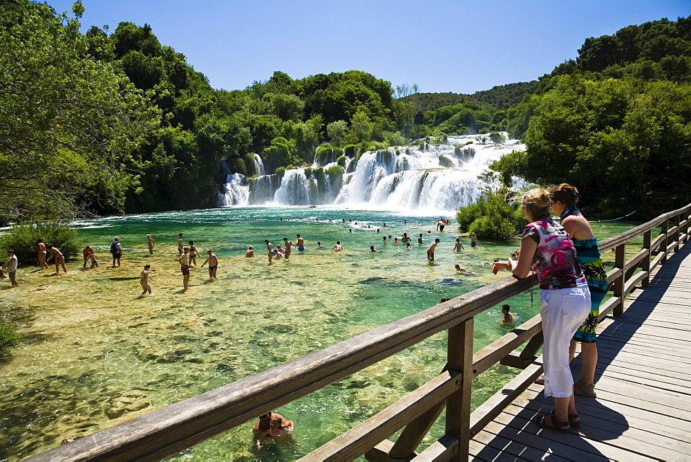 People bathing in the river at Krka waterfalls, Krka National Park, Dalmatia, Croatia, Europe