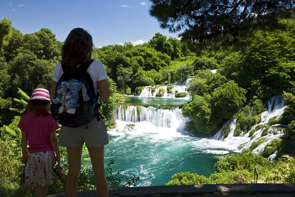 A woman and a child looking at the Krka waterfalls, Krka National Park, Dalmatia, Croatia, Europe