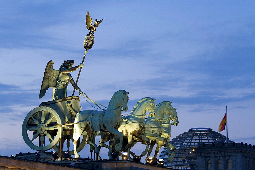 Quadriga, horse and chariot sculpture on Brandenburg Gate, in the background the Reichstag, Berlin