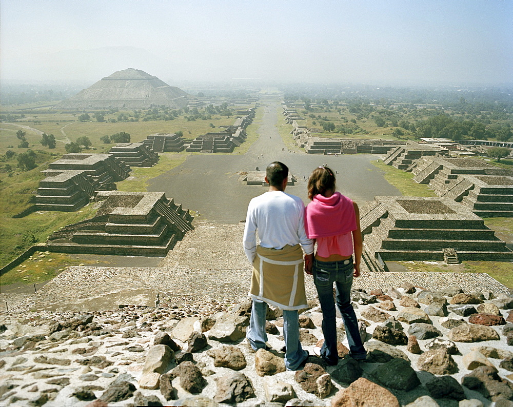 Young couple on top of moon pyramid, view at street of the dead, temple complex Teotihuacan, Mexico, America