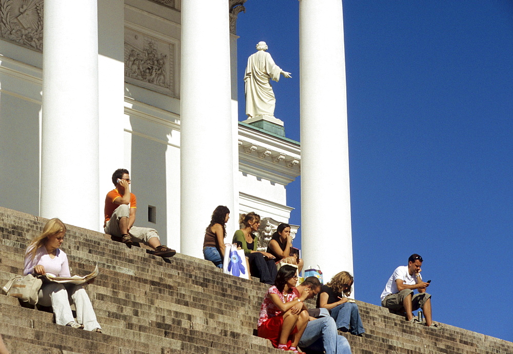 People sitting on the stairs in front of the cathedral, Helsinki, Finland, Europe