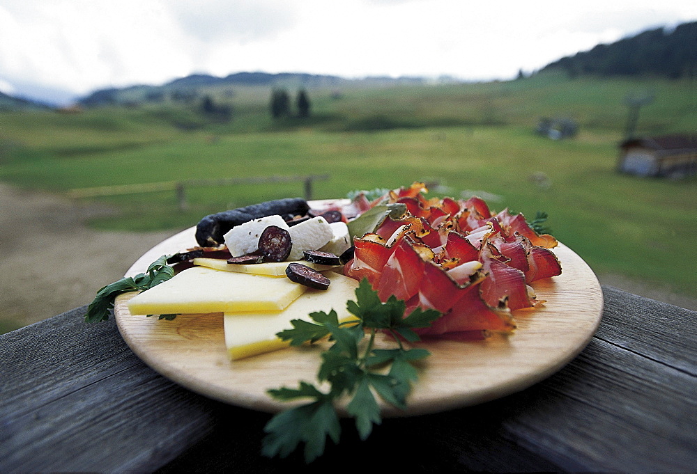 A board with ham and cheese, view at an alp, South Tyrol, Italy, Europe