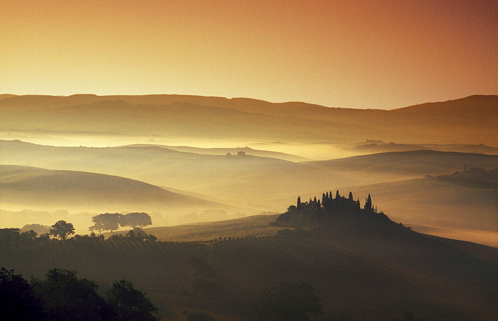 Country house on a hill in the morning mist, Val d'Orcia, Tuscany, Italy, Europe