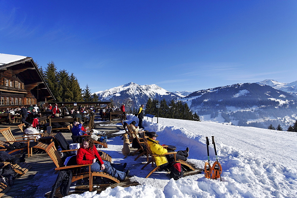 People resting on terrace of a mountain restaurant, Eggli, Gstaad, Bernese Oberland, Canton of Berne, Switzerland