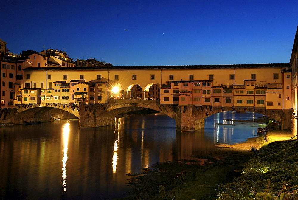 The illuminated Ponte Vecchio under blue sky in the evening, Florence, Tuscany, Italy, Europe