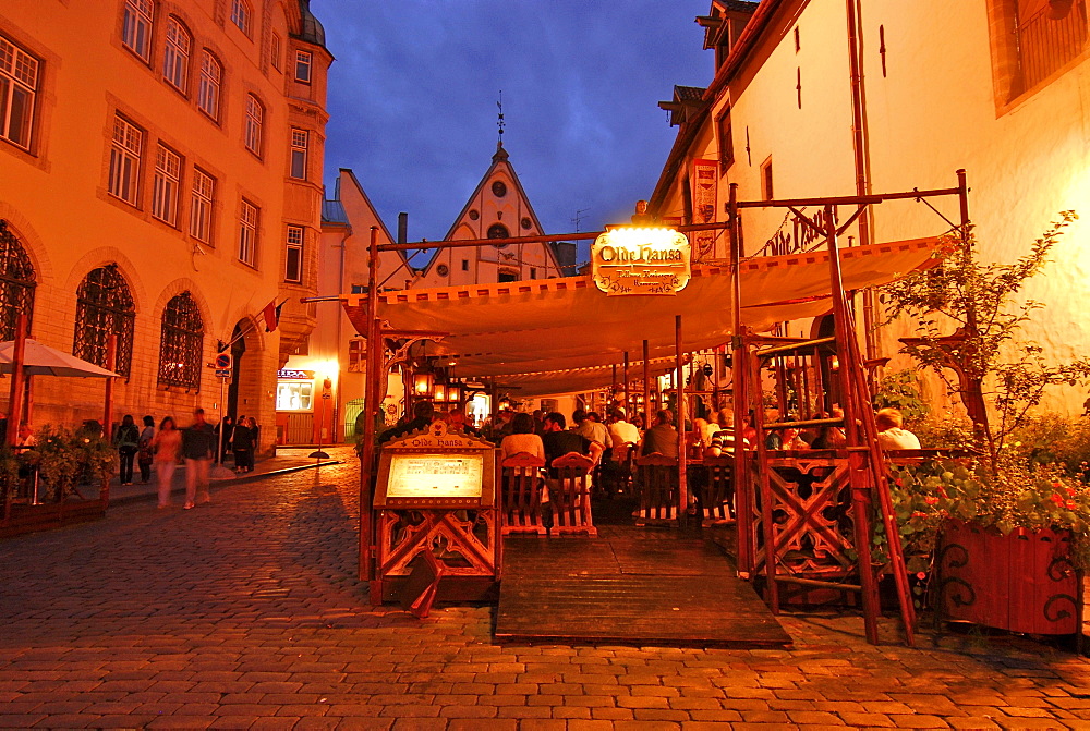 Tables outside the Olde Hansa Restaurant, which serves medievel dishes, evening, Tallinn, Estonia