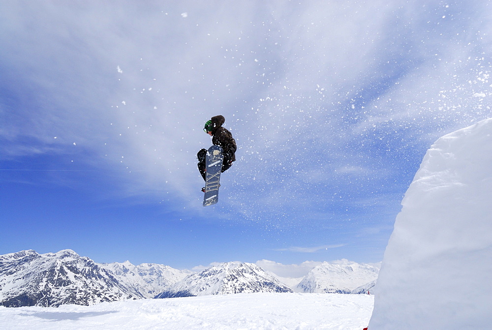 Snowboarder in mid-air, ski area Soelden, Oetztal, Tyrol, Austria