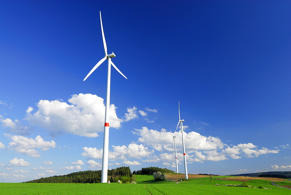 Three wind turbines in meadow, Bavaria, Germany