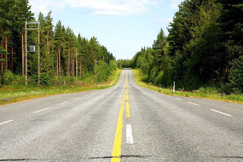 Empty country road between coniferous forests, Saimaa Lake District, Finland, Europe