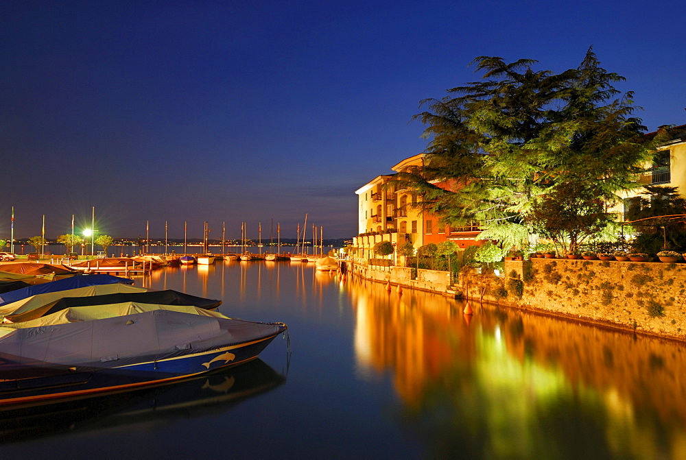 Illuminated harbor, Sirmione, lake Garda, Lombardy, Italy
