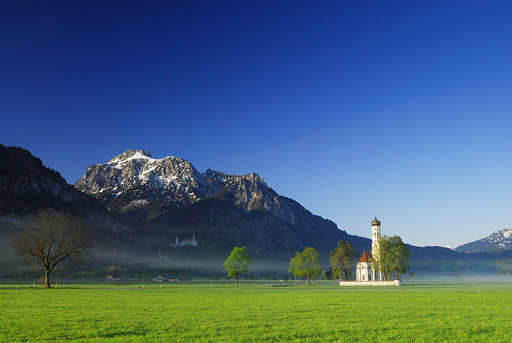 St. Coloman church in morning mist, near Schwangau, Allgaeu, Bavaria, Germany