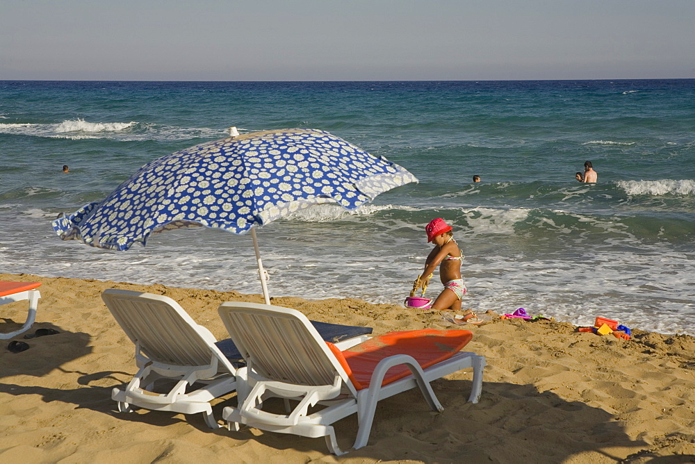 Girl playing on the beach, Golden Sands, Golden Beach, Dipkarpaz, Rizokarpaso, Karpasia, Karpass Peninsula, Cyprus