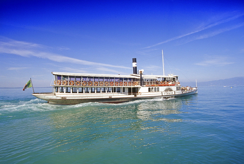 A paddle wheel steamer driving over the lake, Lake Garda, Veneto, Italy, Europe