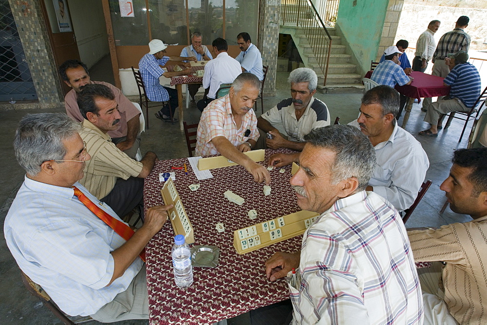 Local men sitting in a cafe playing a game, Kafenion, Dipkarpaz, Rizokarpaso, Karpasia, Karpass Peninsula, Cyprus