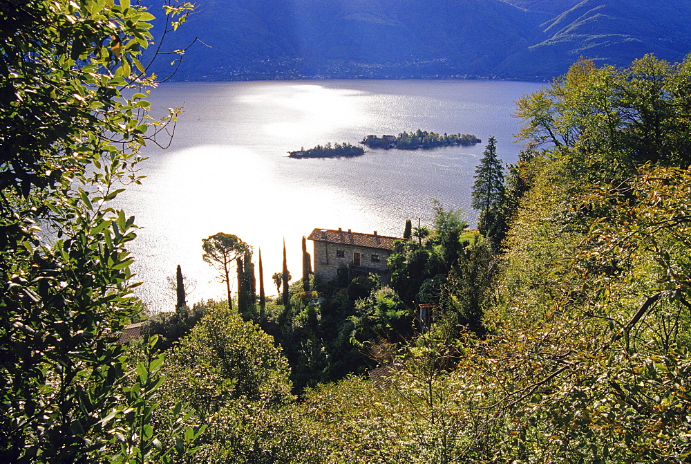 View to a country house and the islands of Brissago in the sunlight, Lago Maggiore, Ticino, Switzerland, Europe