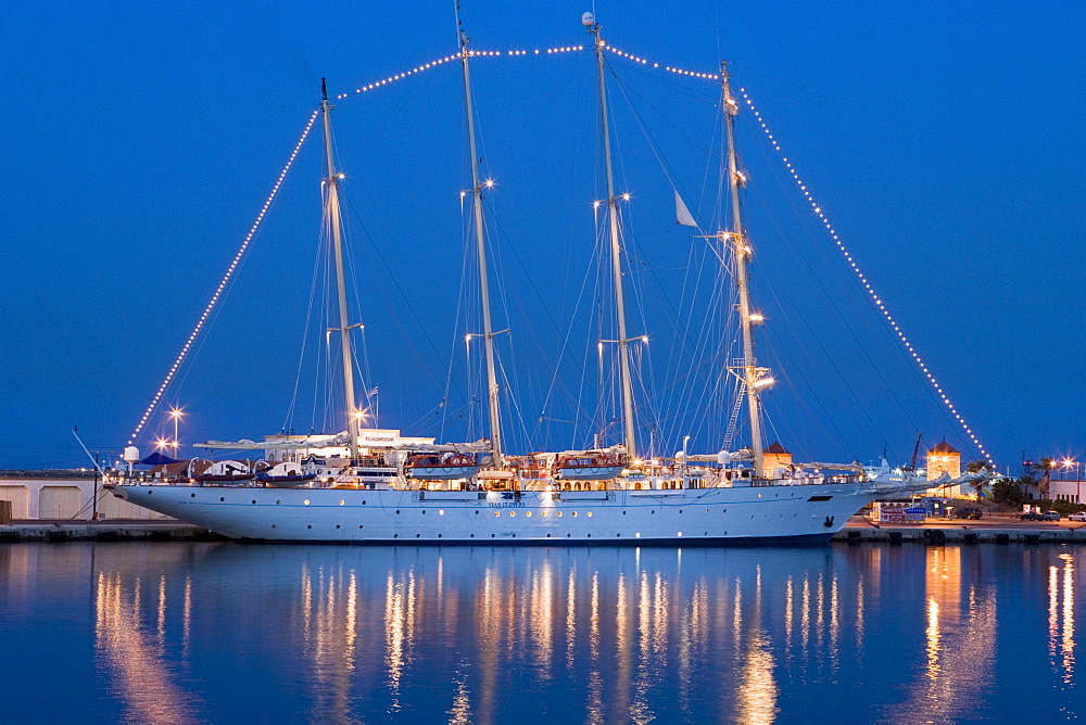 The illuminated sailing ship Star Clipper at Rhodes harbour in the evening, Rhodes city, Rhodes, Greece, Europe