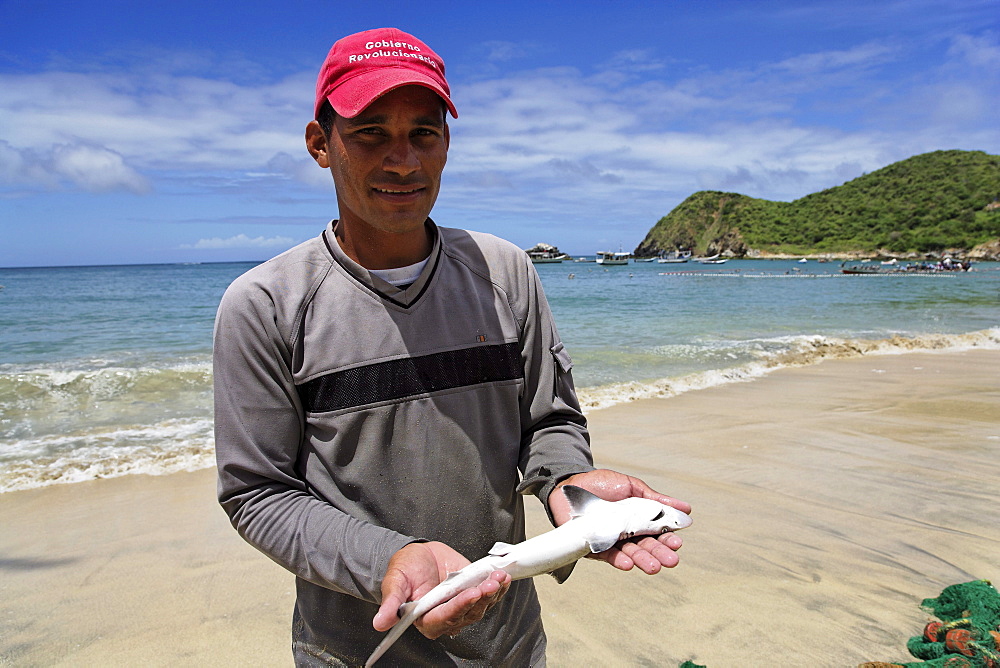 Fisherman holding fish, Playa Guayacan, Isla Margarita, Nueva Esparta, Venezuela