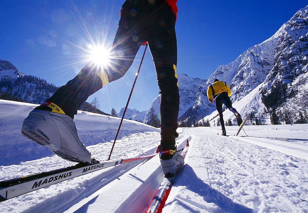 Two cross-country skiers under blue sky, Tyrol, Austria, Europe