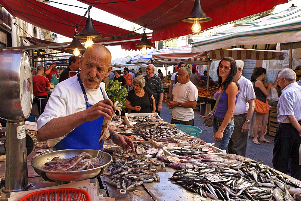 Fishmonger at market, Syracuse, Ortygia island, Sicily, Italy