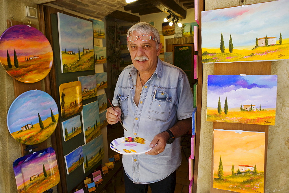 Painter in front of his workshop in Pienza, Tuscany, Italy