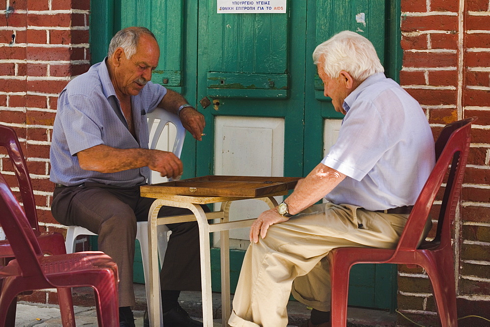 Two older men playing a game outside a cafe, coffee shop, Kafenion, Koilani, Troodos mountains, Cyprus