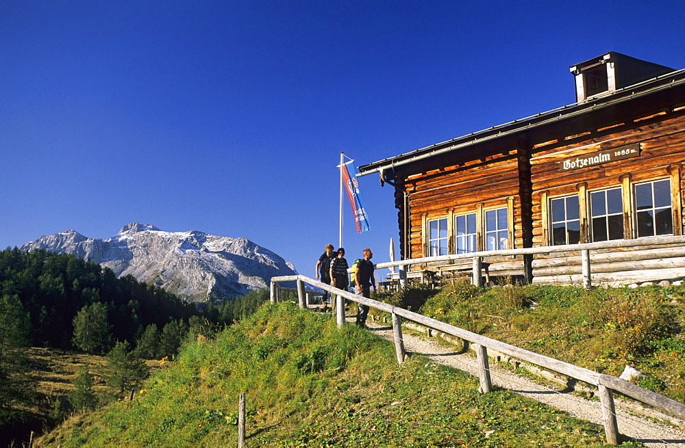 alpine hut Gotzenalm with hikers, Steinernes Meer in background, Berchtesgaden range, Berchtesgaden, Upper Bavaria, Bavaria, Germany