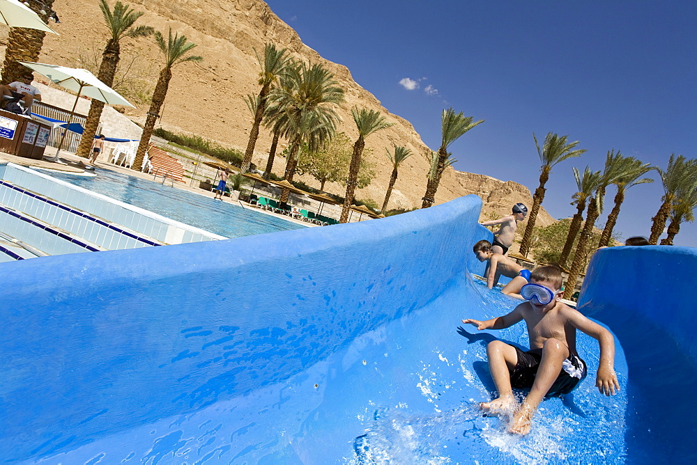 Boys on water slide at the pool of the Meridean Hotel resort, En Bokek, Israel, Middle East