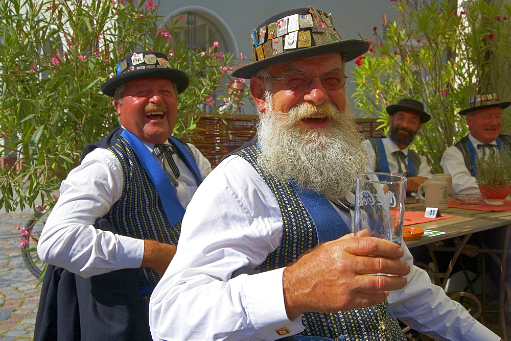 Swiss Group in traditional dress in open air restaurant in the town of Wolfach, Valley Kinzigtal, Southern Part of Black Forest, Black Forest, Baden-Wuerttemberg, Germany, Europe