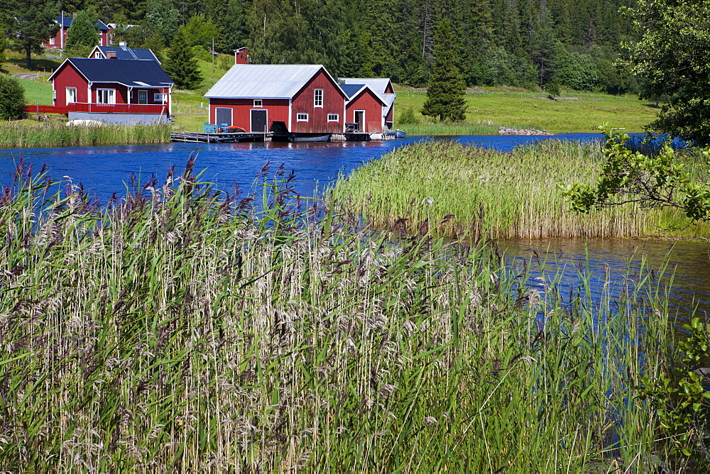 Wooden houses on the waterfront, Faellsvikshamn, Hoega Kusten, Vaesternorrland, Sweden, Europe