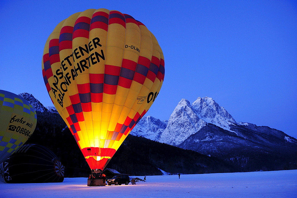 Three hot-air balloons being filled, Waxensteine in background, Garmisch-Partenkirchen, Wetterstein range, Bavarian alps, Upper Bavaria, Bavaria, Germany, Europe