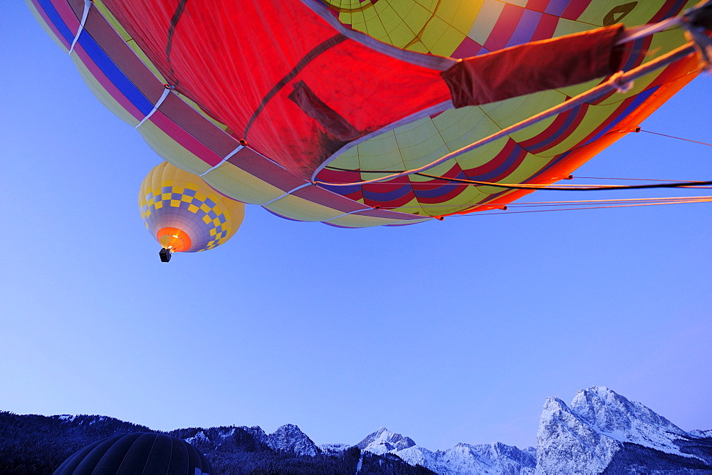 Two hot-air balloons flying one upon the other, Waxensteine in background, Garmisch-Partenkirchen, Wetterstein range, Bavarian alps, Upper Bavaria, Bavaria, Germany, Europe