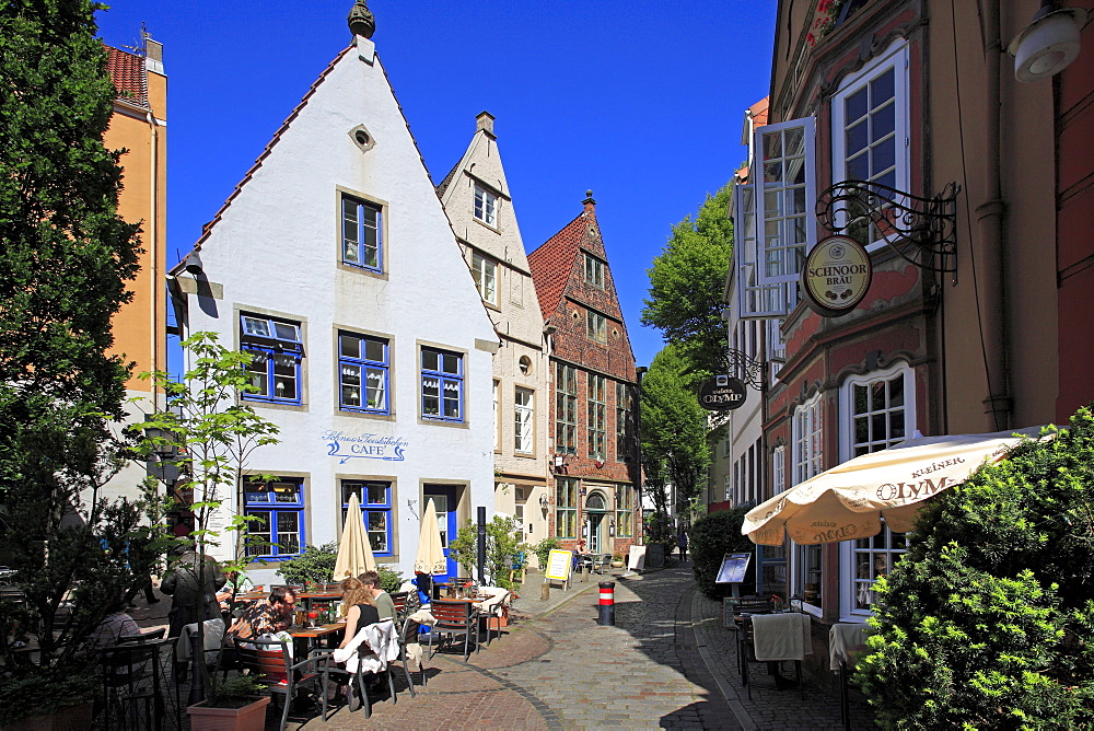 People at street cafe and historical houses at Schnoor quarter, Hanseatic City of Bremen, Germany, Europe