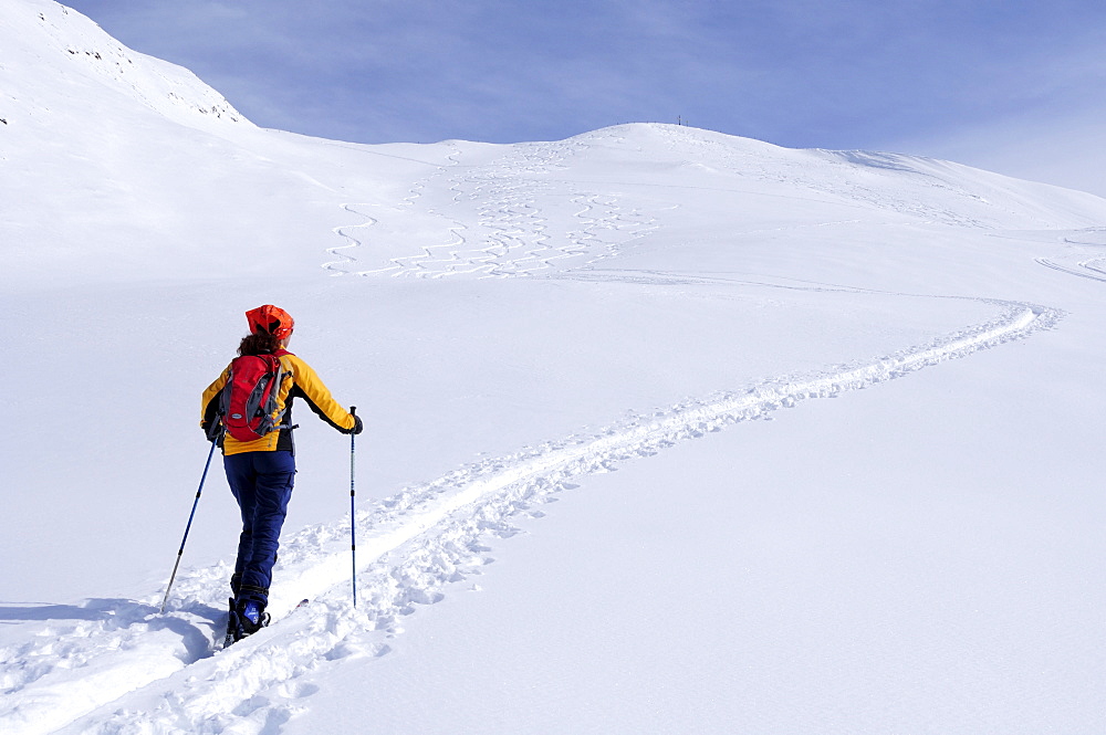 Female backcountry skier ascending to Kreuzeck, Radstaedter Tauern, Niedere Tauern, Salzburg, Austria