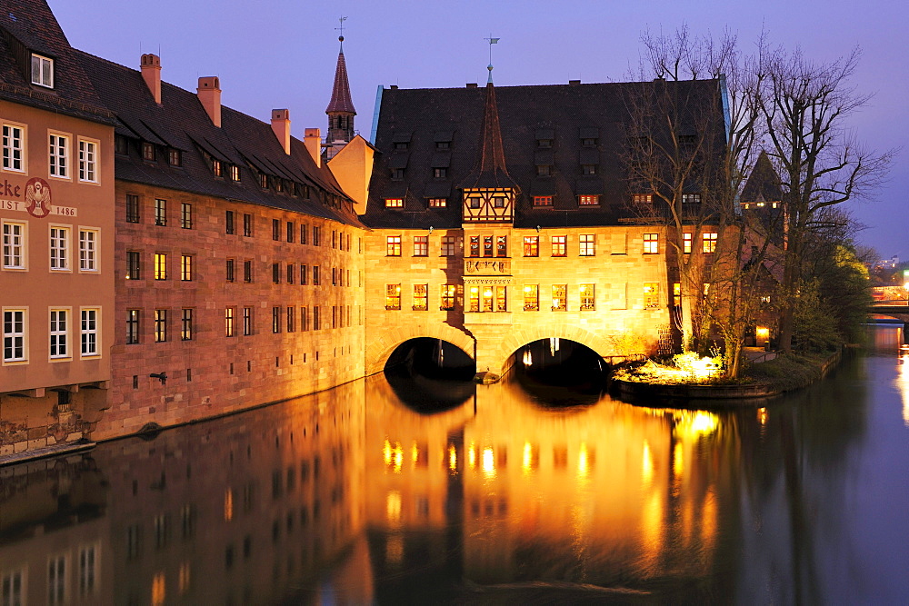 Illuminated Heilig-Geist-Spital with the river Pegnitz at night, Nuremberg, Bavaria, Germany