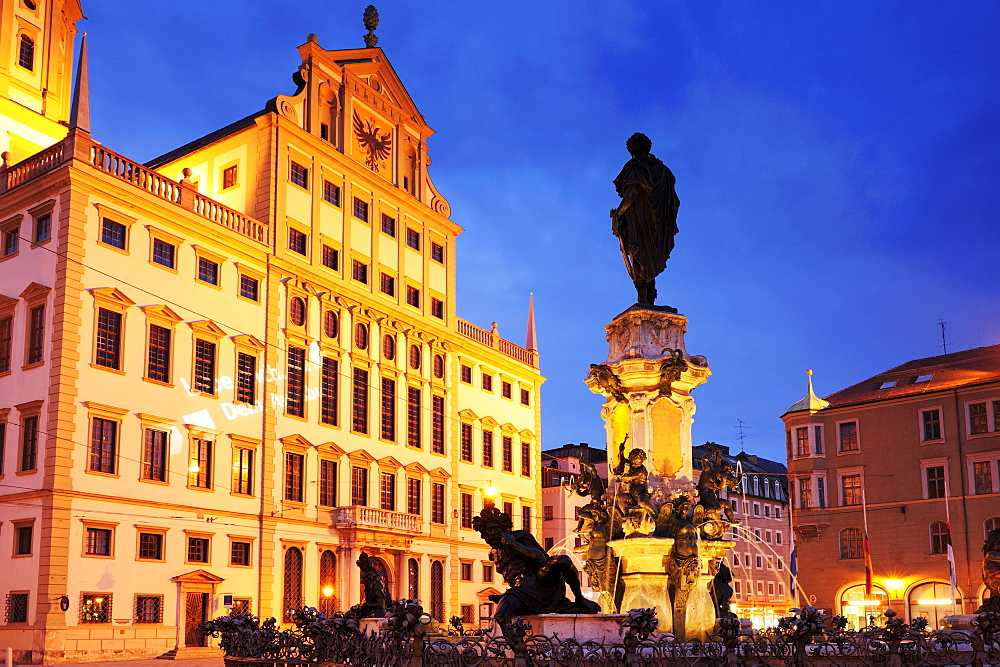 Augustusbrunnen Fountain on Rathausplatz square with illuminated city hall, night shot, Augsburg, Bavaria, Germany