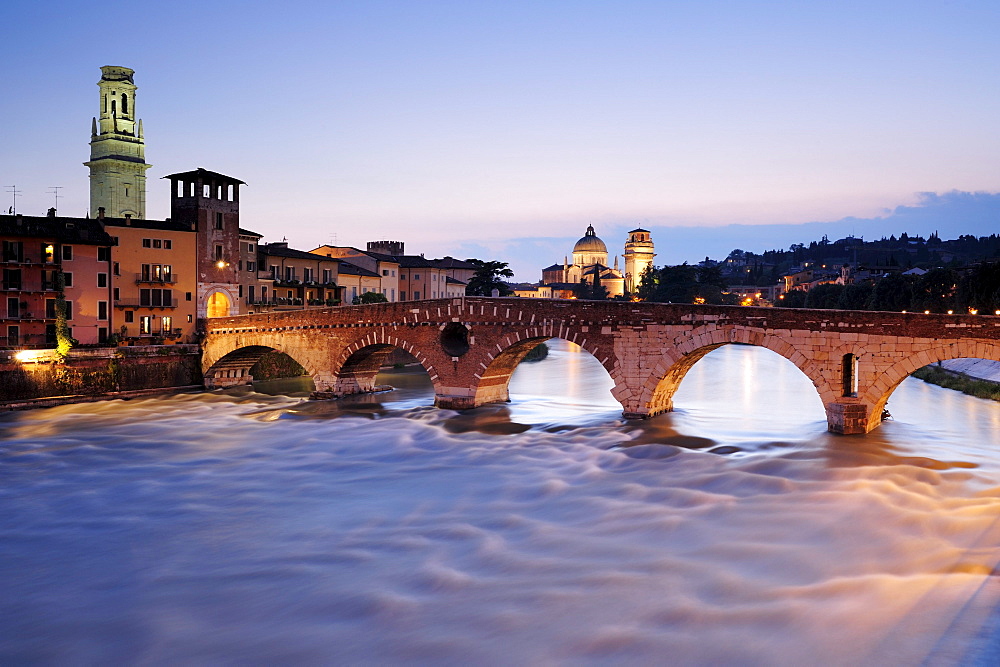 Illuminated bridge Ponte Pietra in the evening light, UNESCO World Heritage Site, Verona, Venetia, Italy