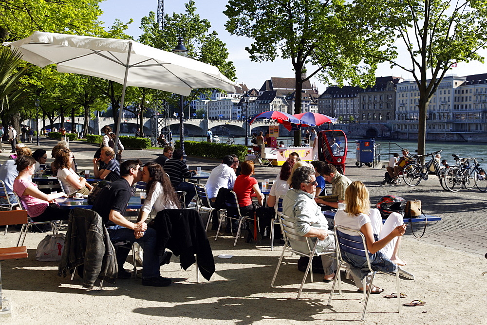 People at a cafe along the banks of the River Rhine, Riviera Klein-Basel, Basel, Switzerland