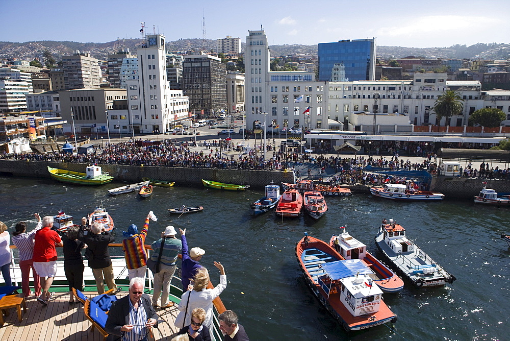 People on deck of cruiseship MS Deutschland (Deilmann Cruises) and view at city as vessel departs, Valparaiso, Chile, South America, America