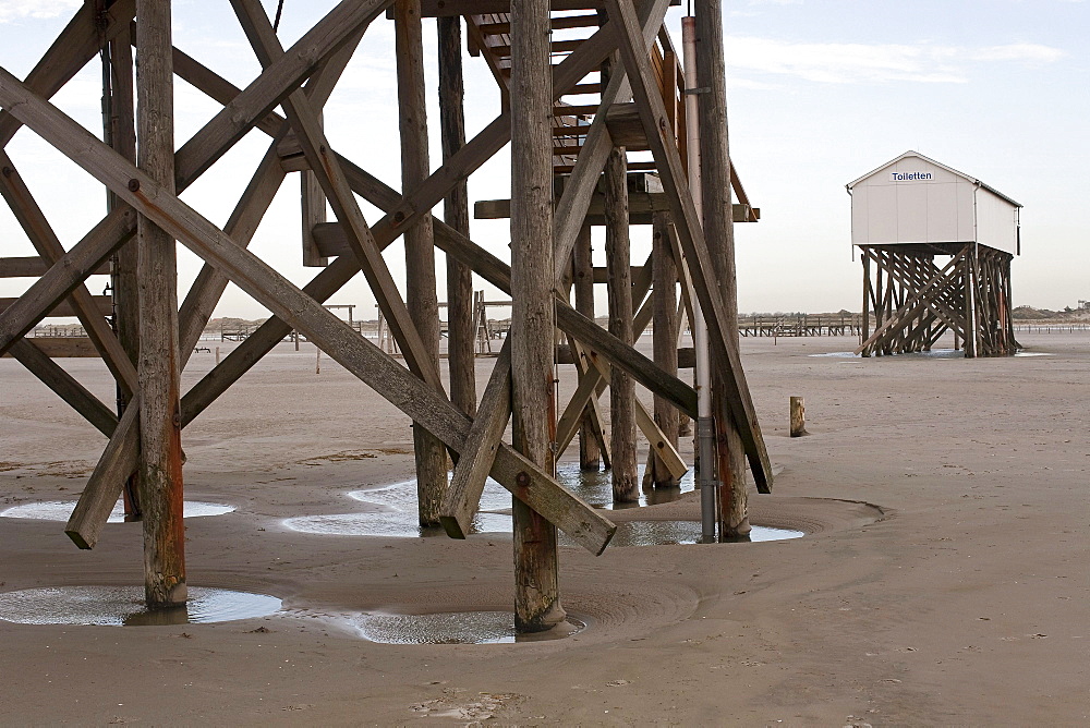 Buildings on stilts, beach at low tide, St Peter-Ording, Schleswig-Holstein, North Sea coast, Germany