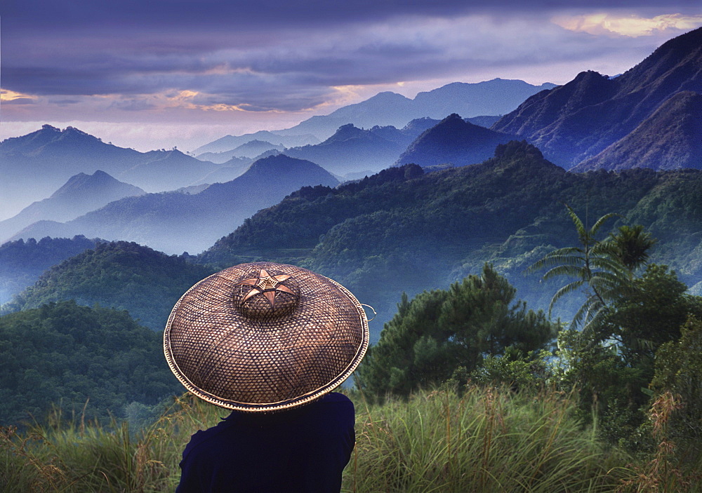 Rice farmer looking at morning mist in the Cordilleras Mountains, Mountain Province, Philippines, Asia