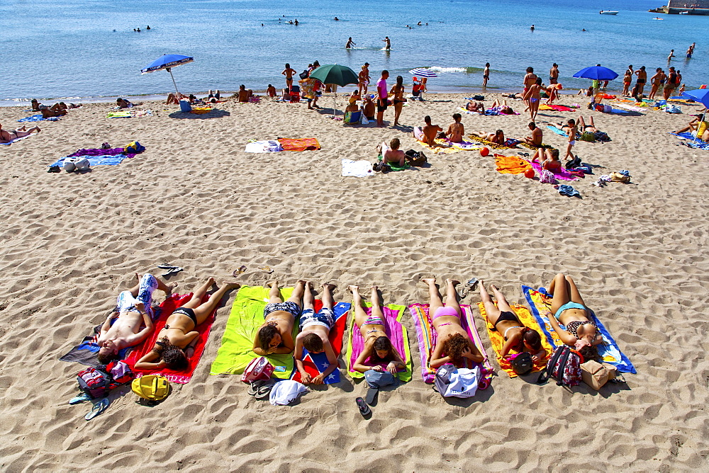 Young people on the beach, CefalË™, Palermo, Sicily, Italy