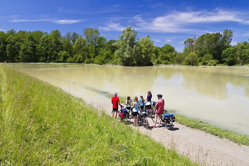 Cyclists on flooded Isar Cycle Route, Isarmuend, Lower Bavaria, Germany