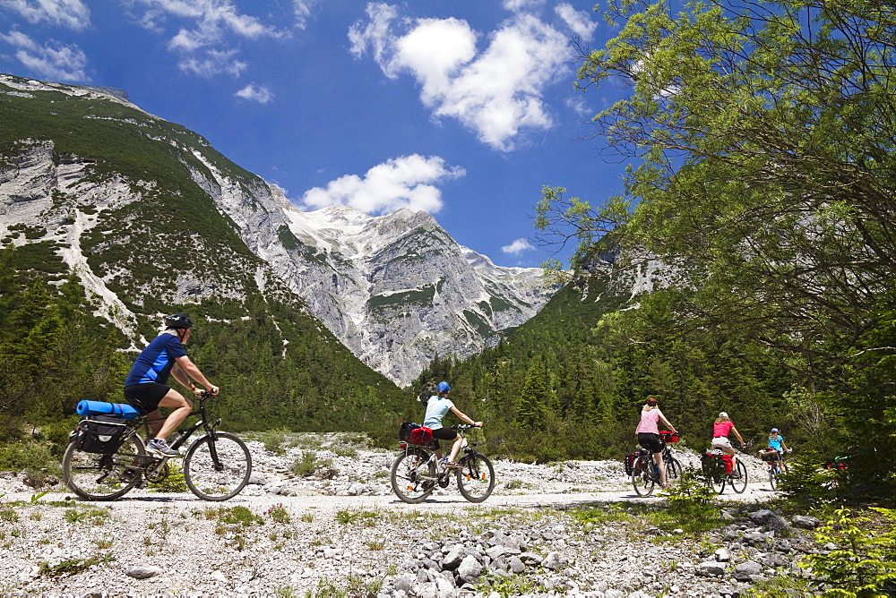 Families cycling along Isar Cycle Route, Hinterau Valley, Karwendel range, Tyrol, Austria